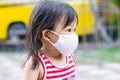 Portrait image of 2-3 yeas old baby. Happy Asian child girl smiling and wearing fabric mask. She playingÃ¢â¬â¹ at the playground. Royalty Free Stock Photo